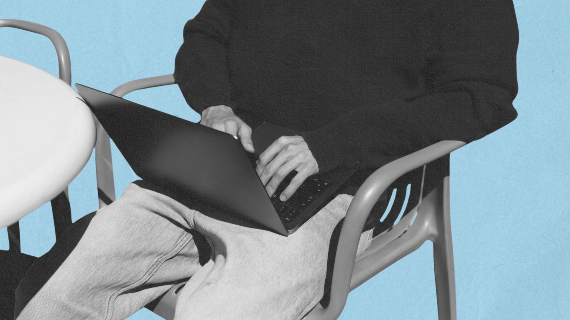 NBH 26-004_Blog_Typography Man sitting down in a chair with a laptop on his lap